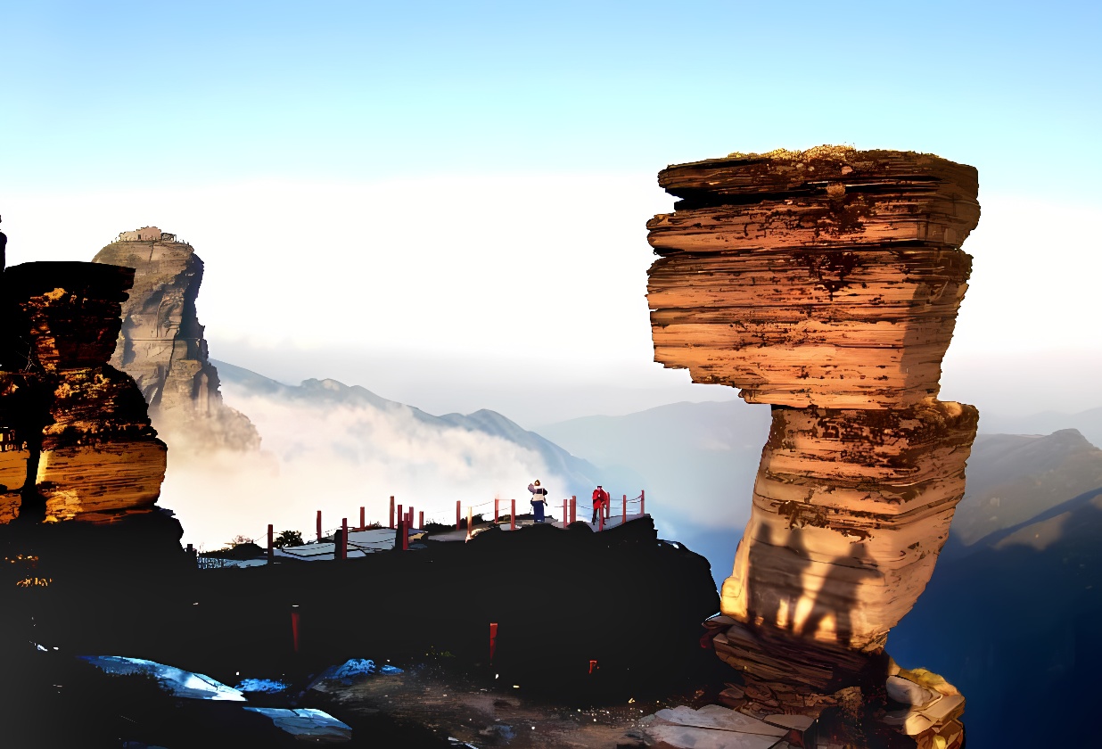 图片展示了壮观的自然风景，两座独特形状的岩石柱耸立，周围云雾缭绕，几人在旁观赏，景色宁静而美丽。