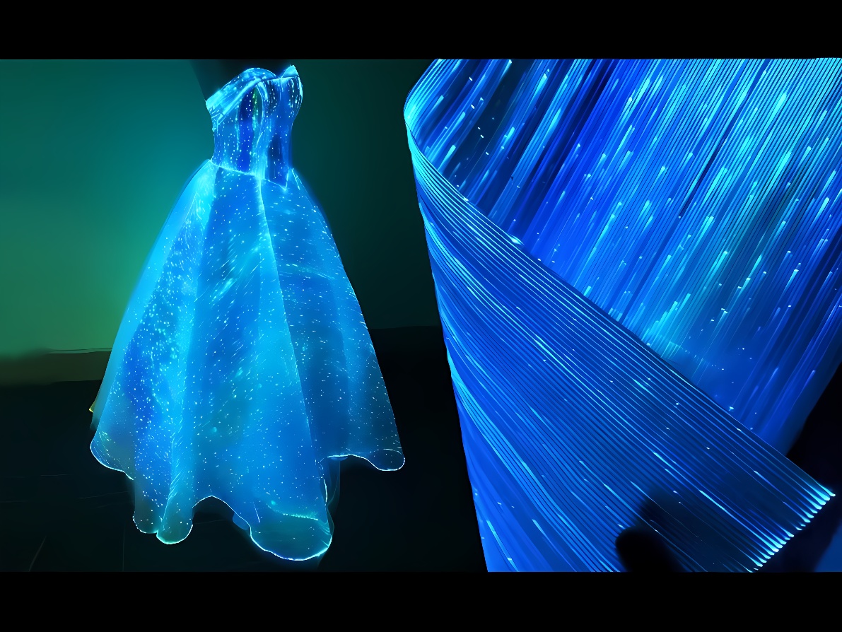图片展示了一件华丽的礼服，呈现出璀璨星空效果，旁边是流畅的蓝色光线，整体营造出梦幻般的视觉体验。