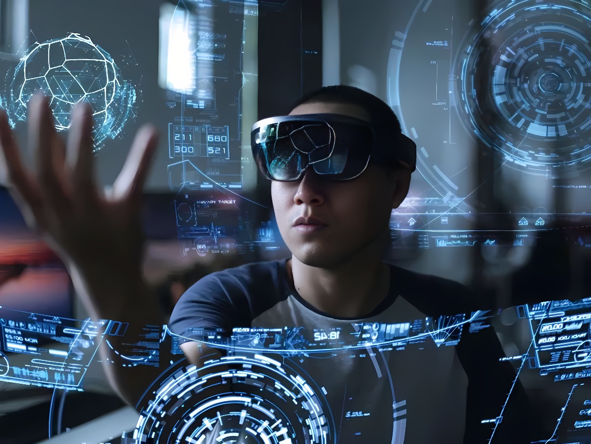 图片展示一位佩戴先进眼镜的人，正用手触摸浮现在空中的虚拟现实界面，周围充满科技感的图形和数据。