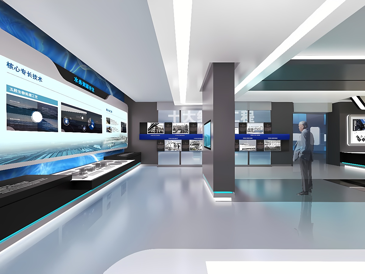 图片展示一个现代风格的展览厅，内有多个屏幕和展示台，一人站立观看，整体色调以蓝白为主，科技感强。