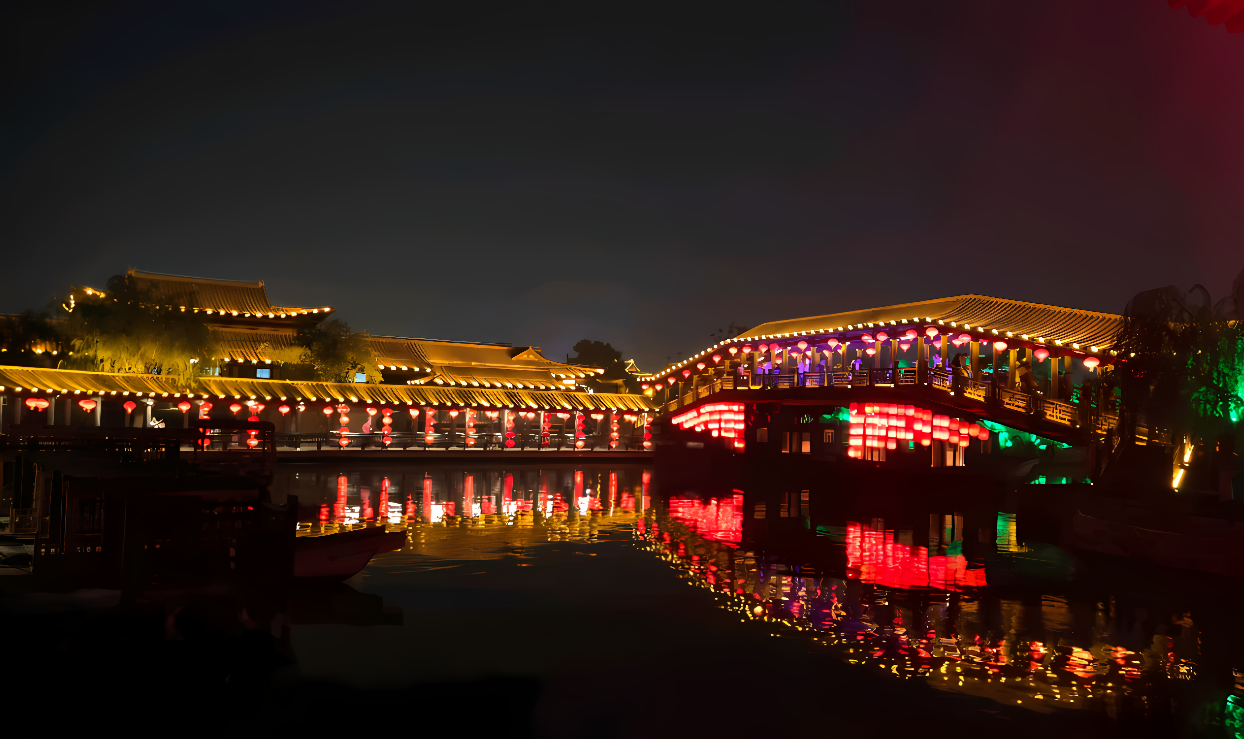 图片展示了夜晚灯火辉煌的古桥和建筑，倒映在平静的水面上，营造出一种宁静而美丽的氛围。