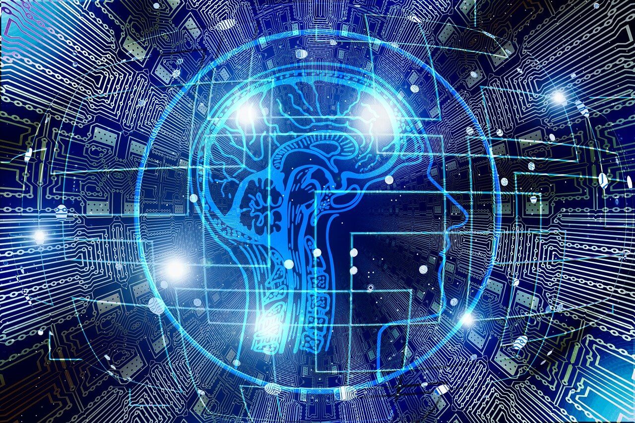这是一张描绘大脑与电路板结合的图片，象征着人工智能或者脑机接口技术，蓝色调显现科技感。