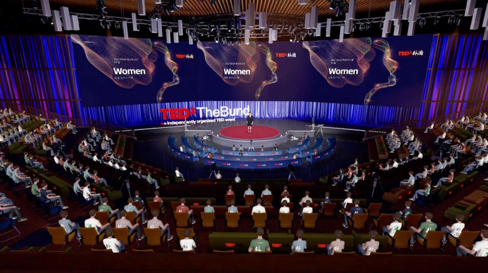 这是一张TEDx活动的照片，台上有演讲者，台下观众聚精会神地听讲。场地布置有TEDx的标志，气氛庄重而专业。