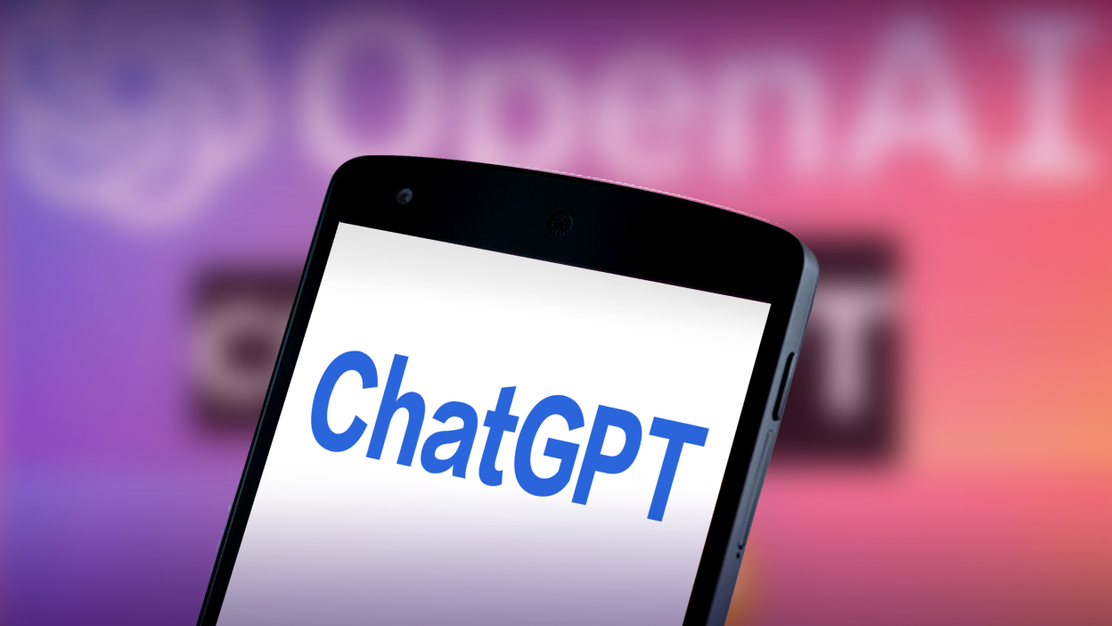 手机屏幕显示“ChatGPT”字样，背景是模糊的“OpenAI”标志，色调为紫色渐变。