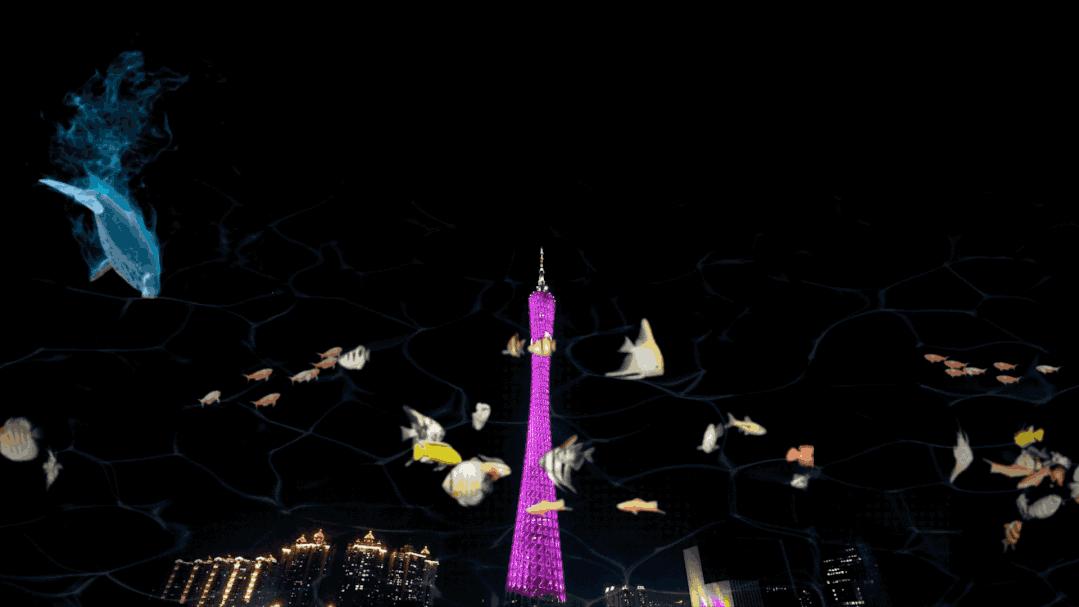 这是一张夜景照片，中间是一座紫色照明的塔，周围有模糊的鱼群图像和深色背景，给人一种梦幻般的视觉效果。
