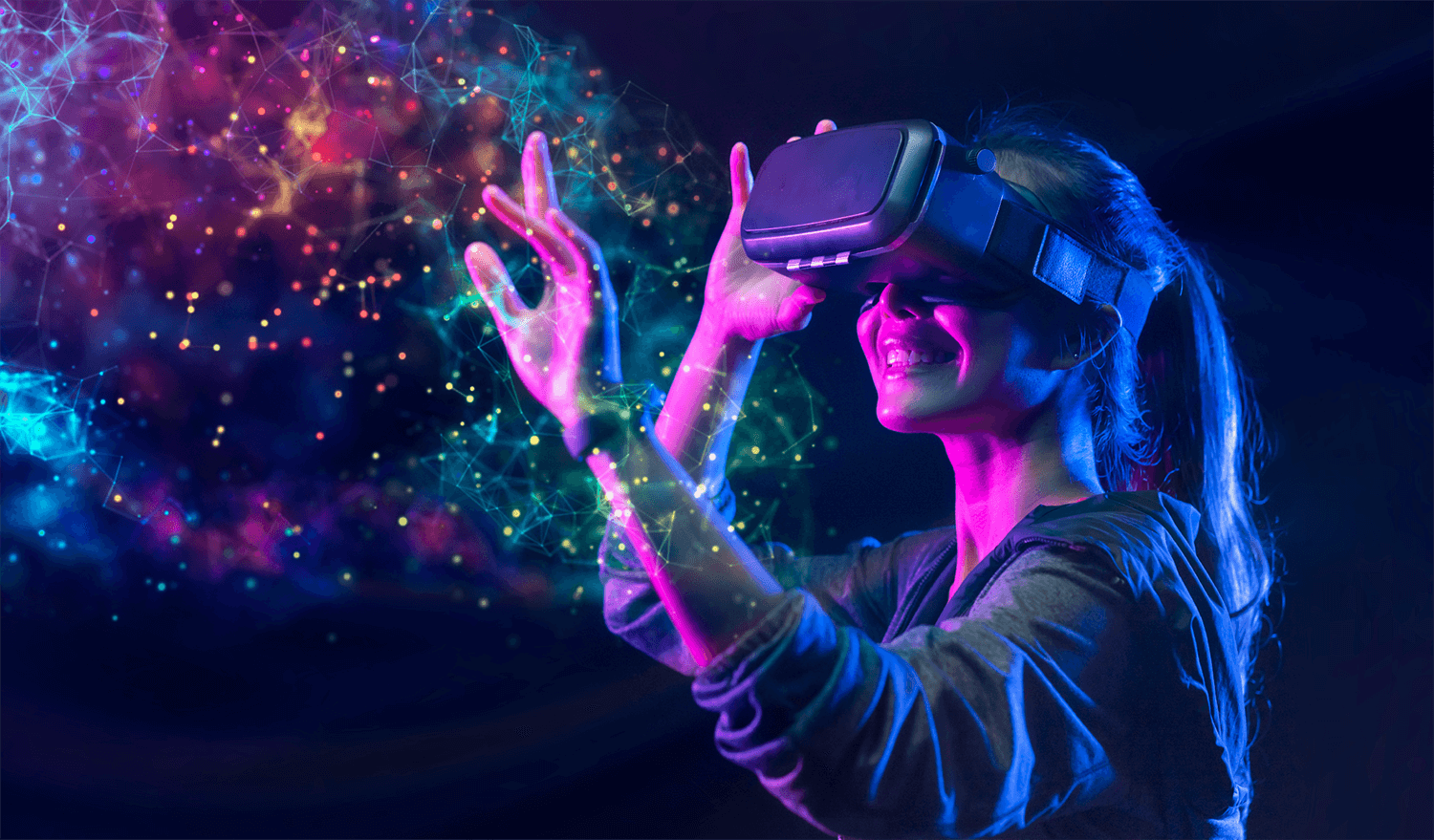 图片展示一位女性戴着虚拟现实头盔，伸出手触摸光点，脸上露出愉悦的表情，背景是充满科技感的彩色光线和节点。