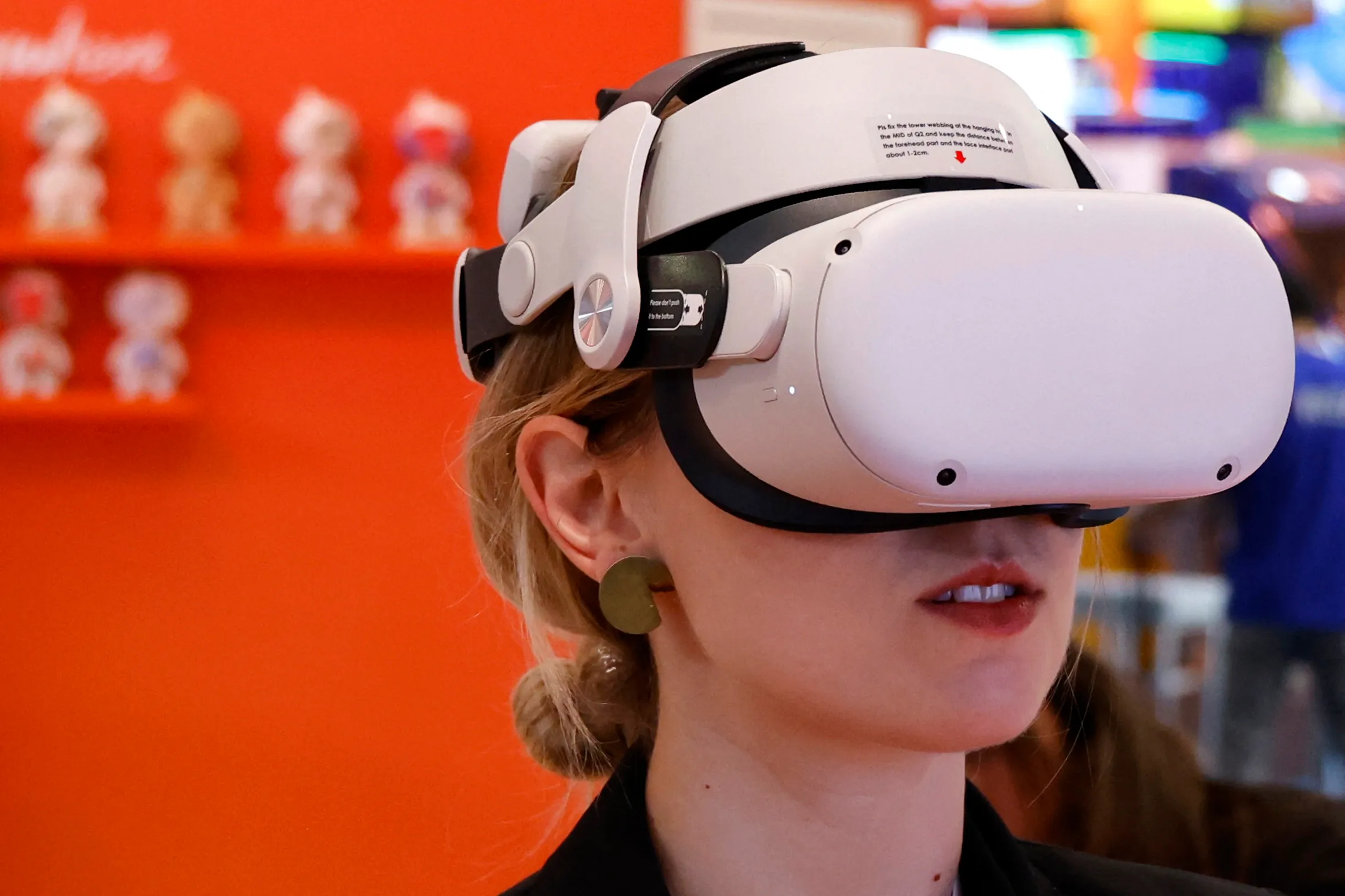 图片展示一位女士戴着头戴式虚拟现实（VR）设备，似乎在体验沉浸式的数字内容。
