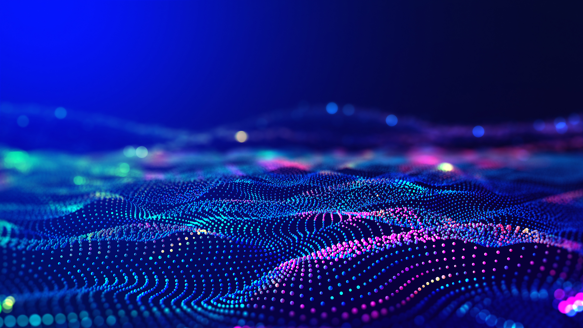 这是一张展示虚拟数字化波纹的图片，颜色丰富，以蓝色为主，呈现出高科技感的动态粒子波浪效果。